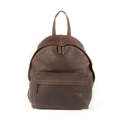 An image of an Adamonde brown leather backpack. The backpack has a classic, minimalist design with two adjustable straps and a handle on the top. It features multiple compartments with zippers, pockets, and a front flap closure. The leather material appears to be smooth and well-worn, giving it a vintage and timeless look